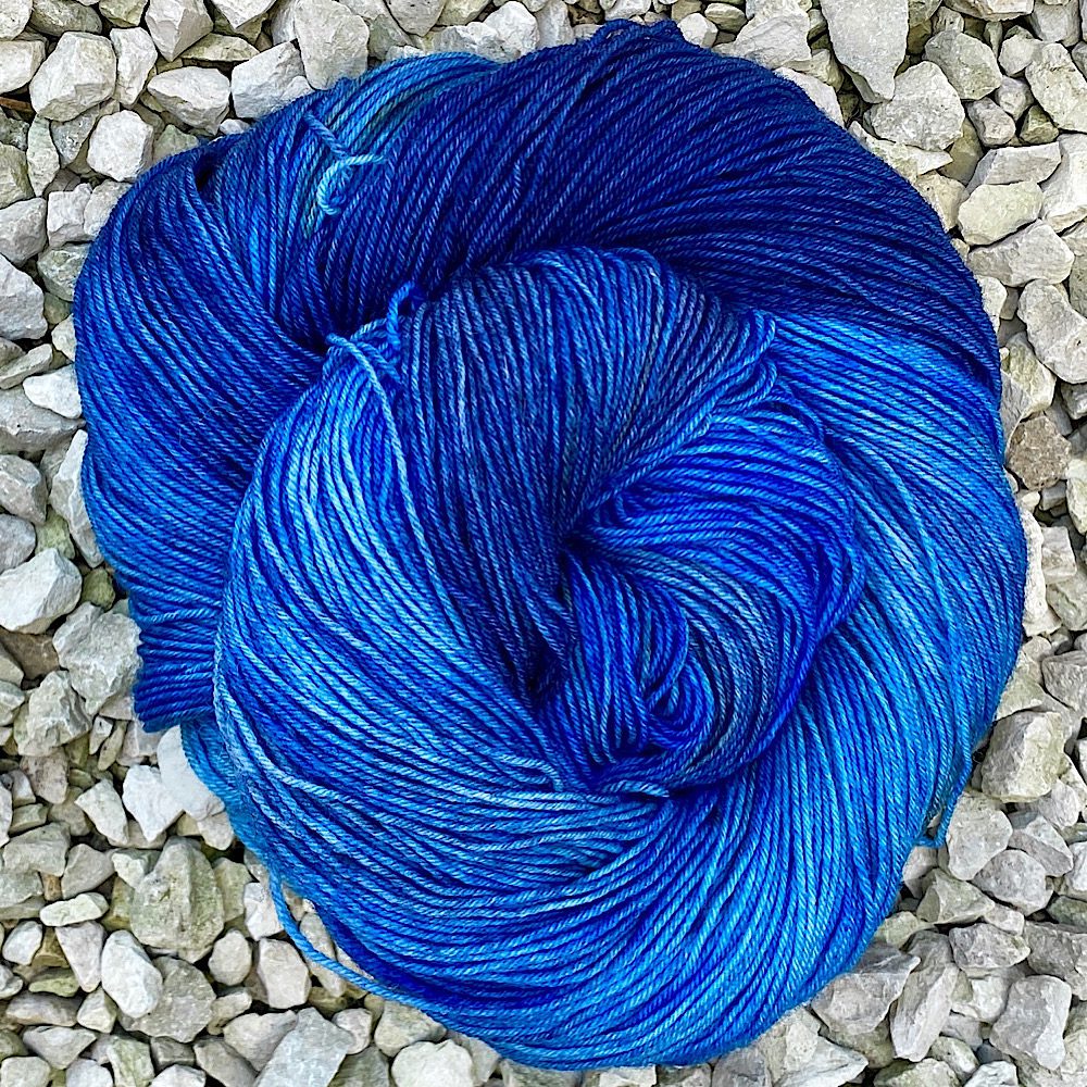 100% BFL wool hand dayed in coloue 'Say Yes!. A variegated hand-dye of pale to deep blues with some brown speckling