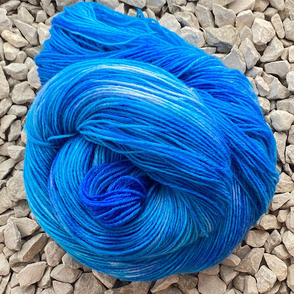 Swirl of hand-dyed yarn in pale to deep blues