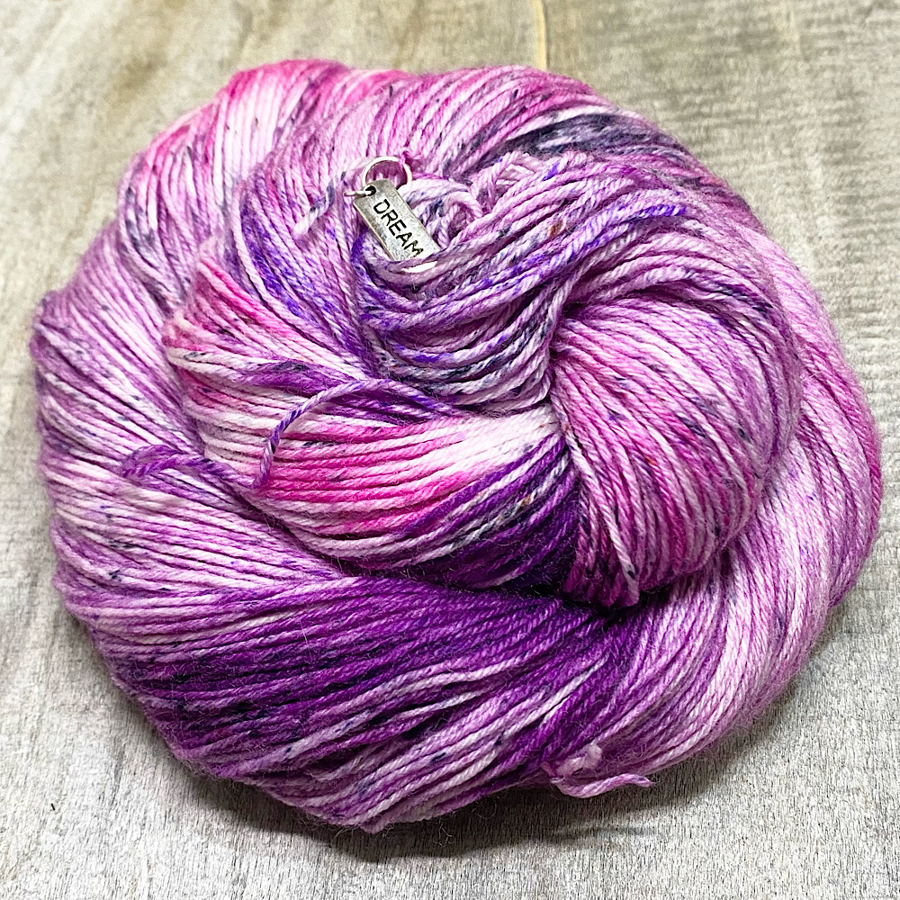 A swirl of hand dyed yarn showing the range of purples