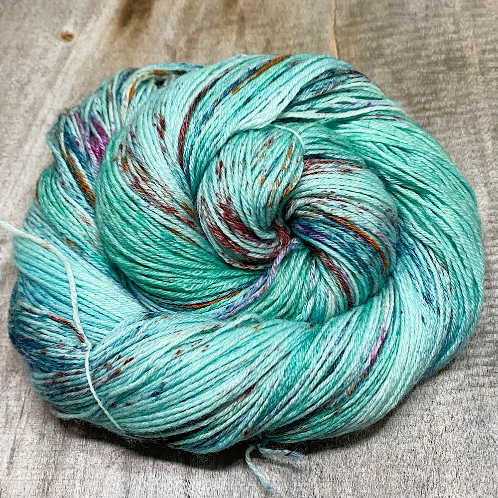 A skein of hand-dyed MCN yarn hand-dyed in colour, 'Rock Pool'