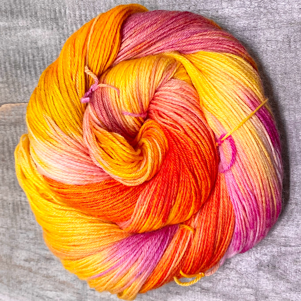 A skein of MCN, hand dyed in sunset colours